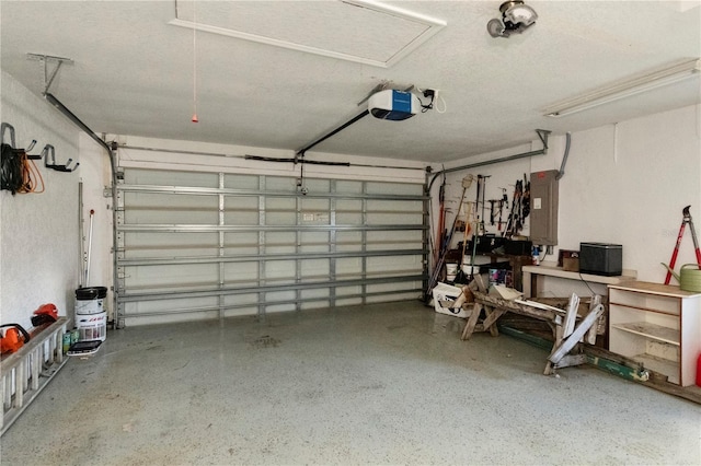 garage featuring electric panel and a garage door opener