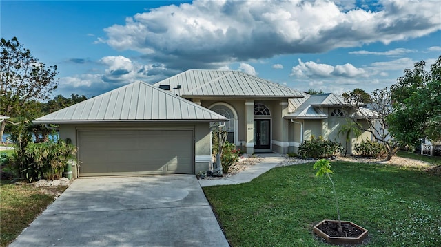 view of front of property with a garage and a front lawn