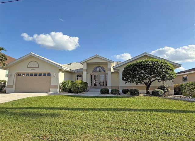 single story home with french doors, a garage, and a front lawn