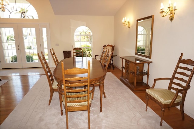 dining room with french doors and hardwood / wood-style flooring