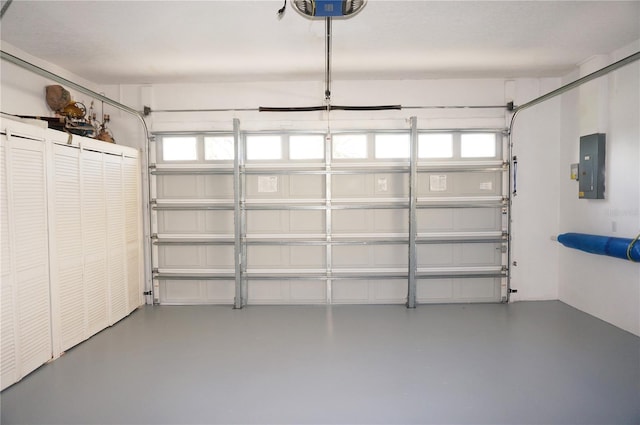 garage featuring a garage door opener and electric panel