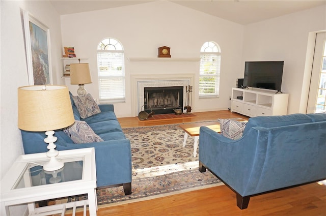 living room with hardwood / wood-style floors and vaulted ceiling