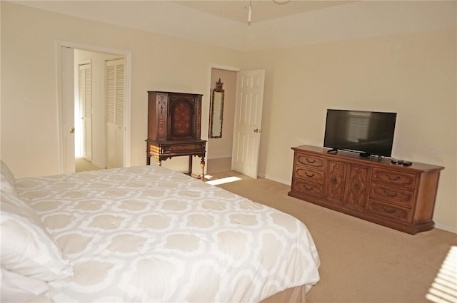 bedroom with light carpet and a closet