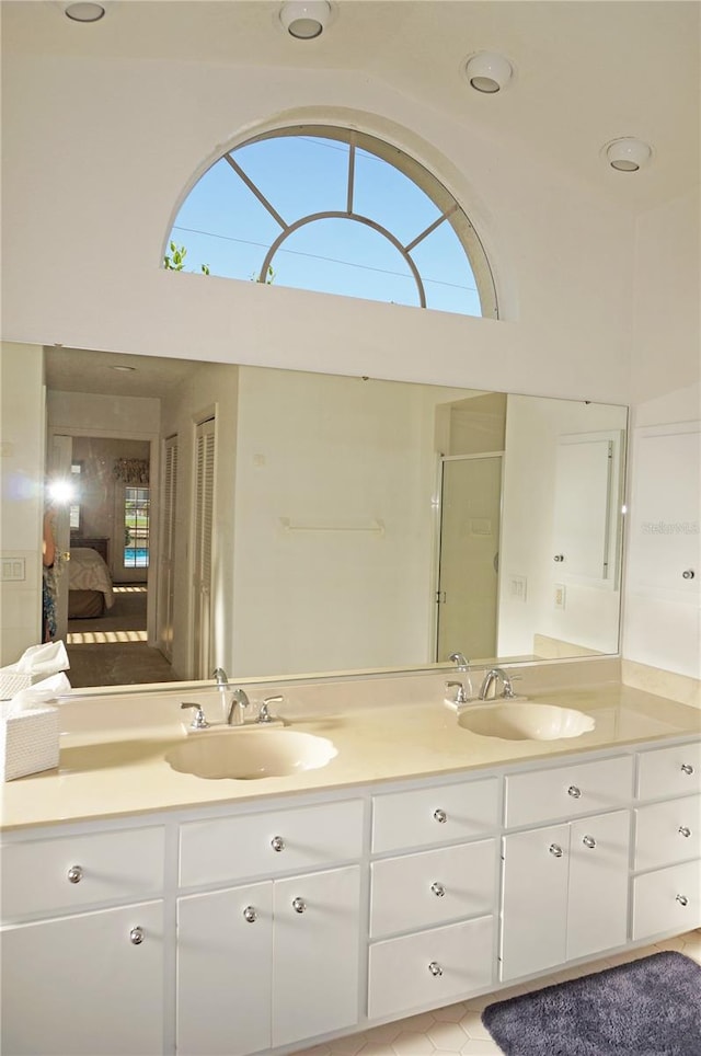 bathroom with a towering ceiling and vanity