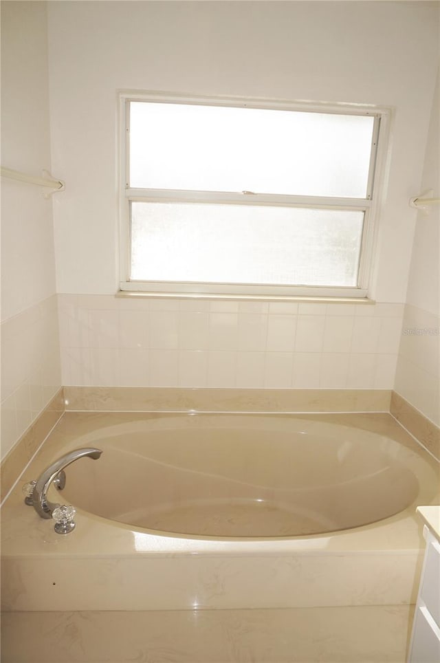 bathroom with vanity and a bathing tub