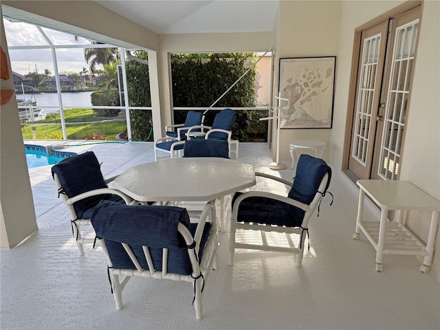 sunroom / solarium with a water view