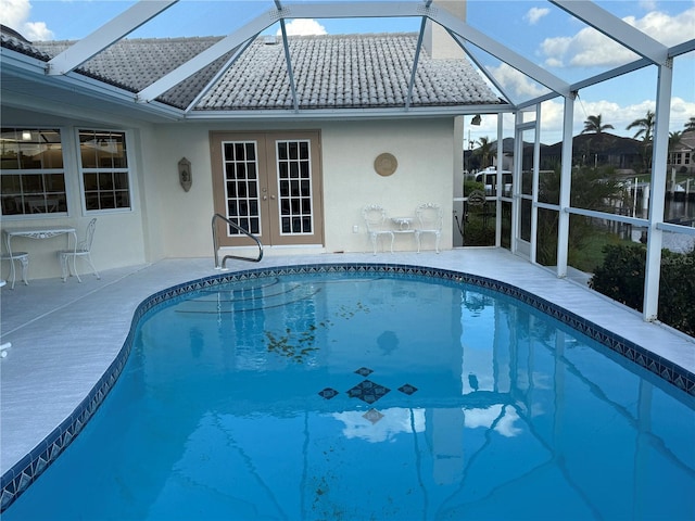 view of swimming pool featuring a lanai and a patio area