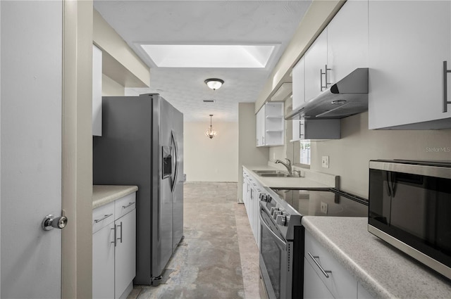 170 Chelsea Ct NW, Port Charlotte, FL 33952 - kitchen with stainless steel appliances, under cabinet range hood, white cabinets, and light countertops