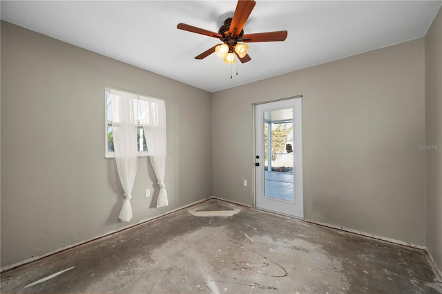 unfurnished room featuring ceiling fan and a healthy amount of sunlight