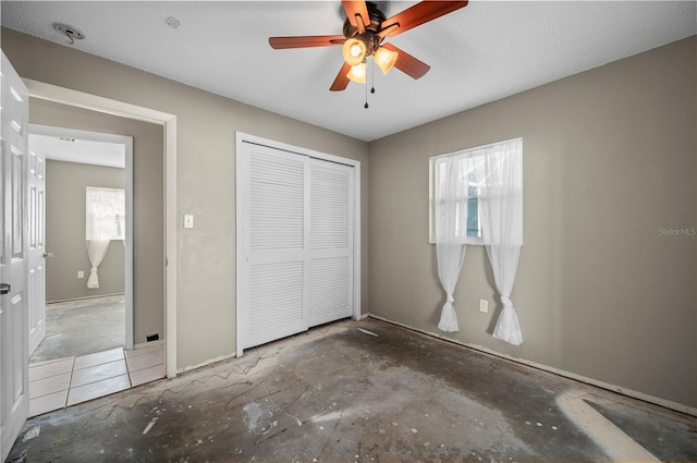 unfurnished bedroom with ceiling fan, a closet, and a textured ceiling