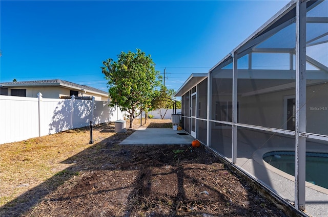 view of yard with a patio, a fenced in pool, and a lanai