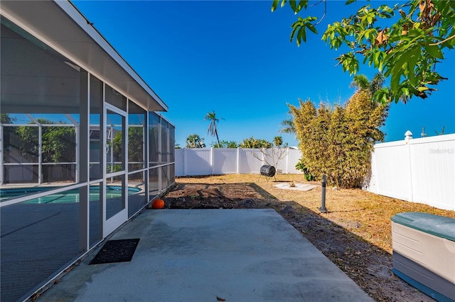 view of patio featuring glass enclosure and a fenced in pool