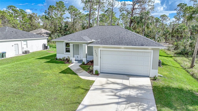 view of front of house featuring a front lawn, central AC unit, and a garage