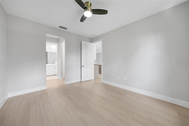 empty room featuring ceiling fan and light hardwood / wood-style floors