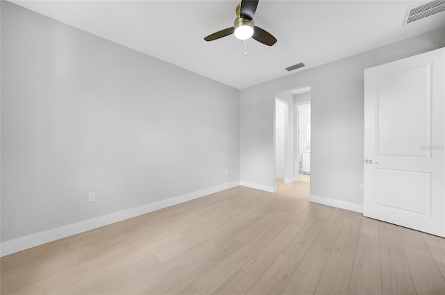 empty room with ceiling fan and light hardwood / wood-style floors