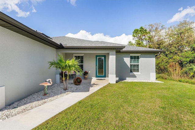 4340 Adolph Ave, North Port, FL 34288 - rear view of property with stucco siding and a yard
