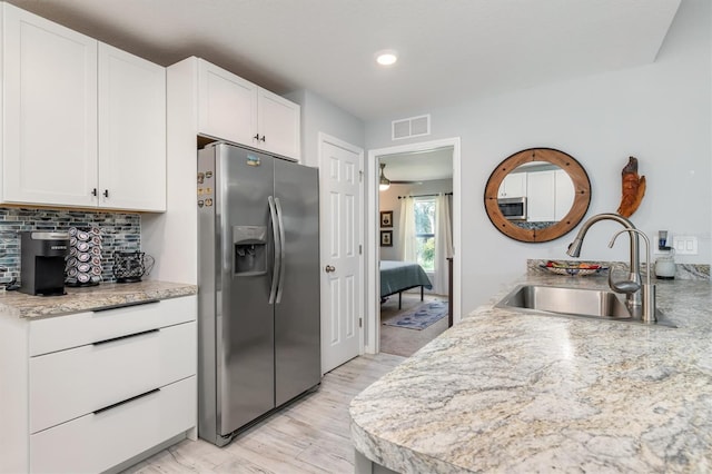 4340 Adolph Ave, North Port, FL 34288 - kitchen with stainless steel refrigerator with ice dispenser, a sink, white cabinets, light countertops, and recessed lighting