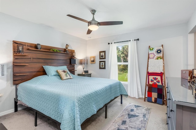 bedroom featuring light colored carpet and ceiling fan