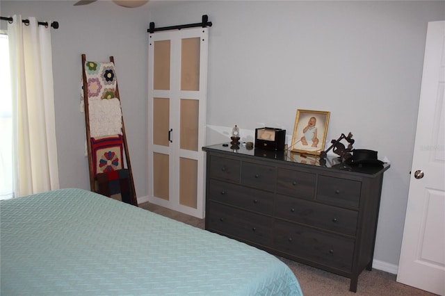4340 Adolph Ave, North Port, FL 34288 - bedroom featuring a barn door, carpet, and baseboards