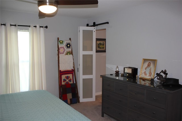4340 Adolph Ave, North Port, FL 34288 - bedroom featuring a barn door, light colored carpet, and a ceiling fan