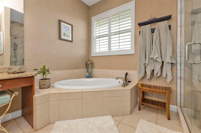 bathroom featuring plus walk in shower, tile patterned floors, and vanity