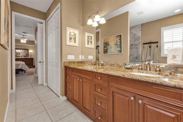 bathroom with tile patterned flooring, vanity, a shower with door, and an inviting chandelier