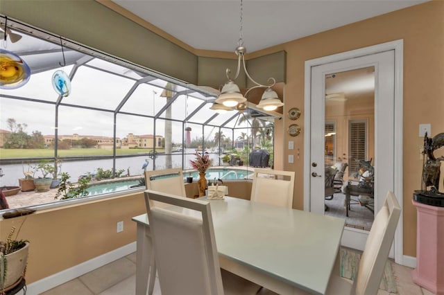 tiled dining space featuring a water view