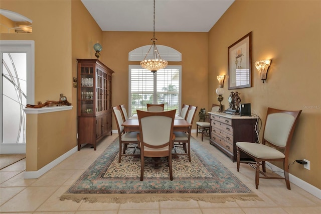 tiled dining space with an inviting chandelier