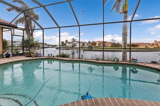 view of pool with a patio, a water view, and glass enclosure