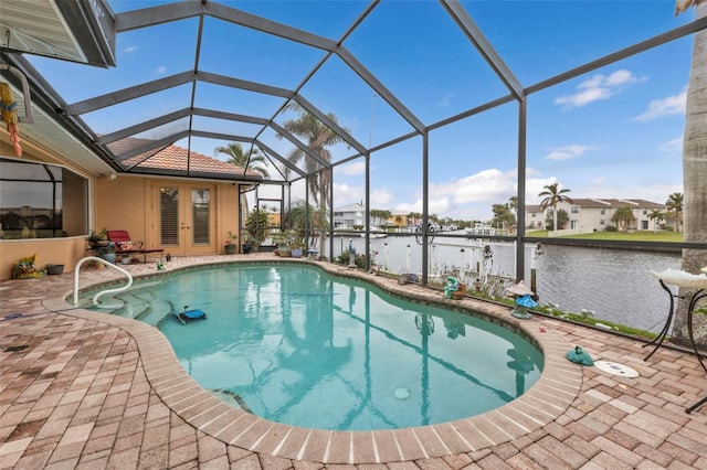 view of swimming pool with a water view, a patio, glass enclosure, and french doors