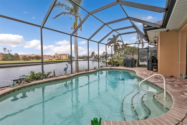 view of swimming pool featuring a patio area, grilling area, a water view, and glass enclosure