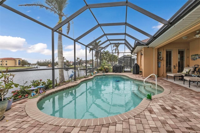 view of pool featuring a water view, a grill, a lanai, and a patio