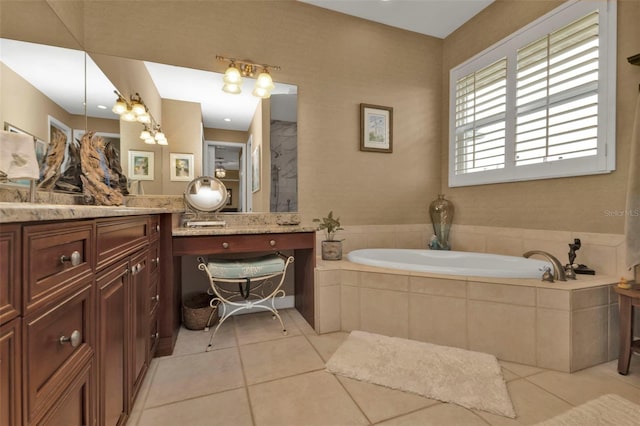 bathroom featuring vanity, a relaxing tiled tub, and tile patterned floors