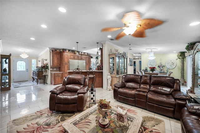 tiled living room with ceiling fan and crown molding