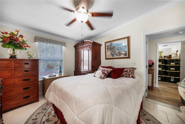 bedroom with ornamental molding, ceiling fan, and light tile patterned floors