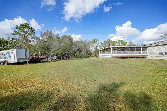 view of yard featuring a sunroom