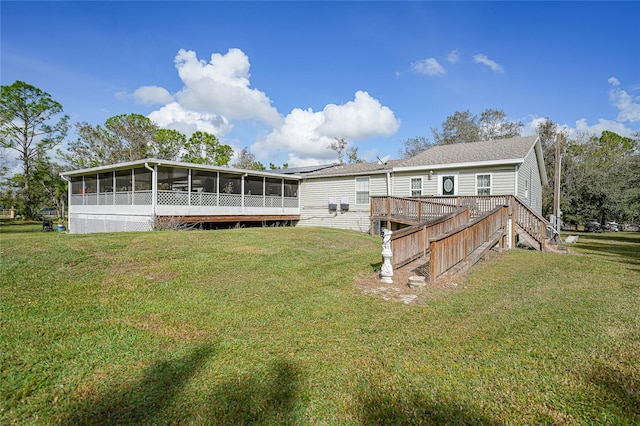 rear view of house with a sunroom and a lawn