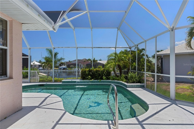 view of pool with a water view, glass enclosure, and a patio area