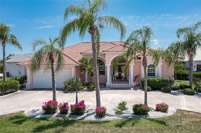 mediterranean / spanish home with a garage