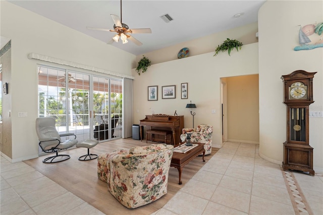 living room featuring light tile patterned floors and ceiling fan