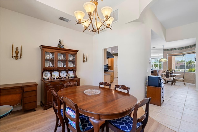 tiled dining room featuring an inviting chandelier