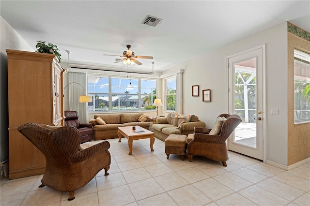 living room featuring light tile patterned floors and ceiling fan