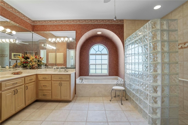 bathroom with independent shower and bath, vanity, and tile patterned flooring