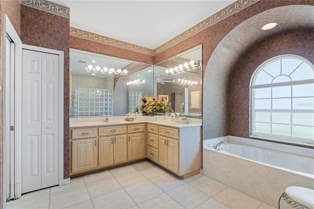 bathroom featuring a bath, tile patterned flooring, and vanity