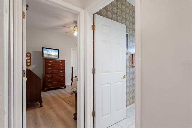 hallway with light hardwood / wood-style floors