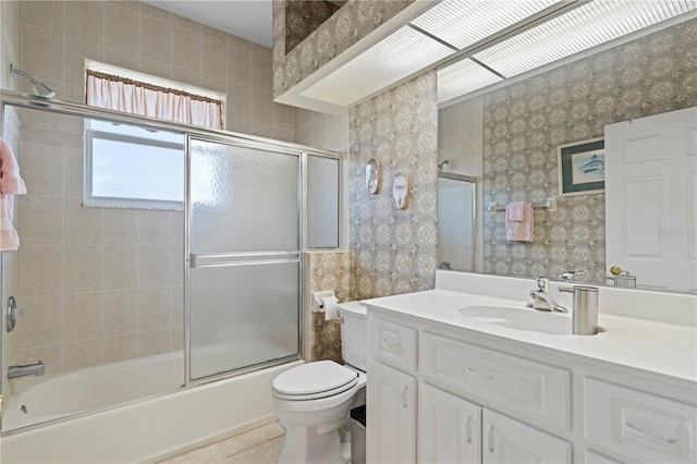 full bathroom with enclosed tub / shower combo, tile patterned flooring, vanity, and toilet