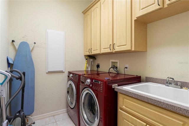 laundry room with washer and clothes dryer, cabinets, sink, and light tile patterned floors