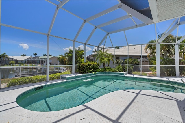 view of swimming pool with glass enclosure and a patio area