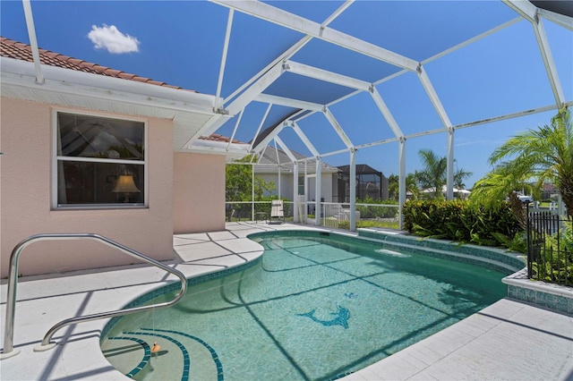 view of pool featuring glass enclosure and a patio area