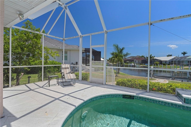 view of pool with a patio, a water view, and a lanai